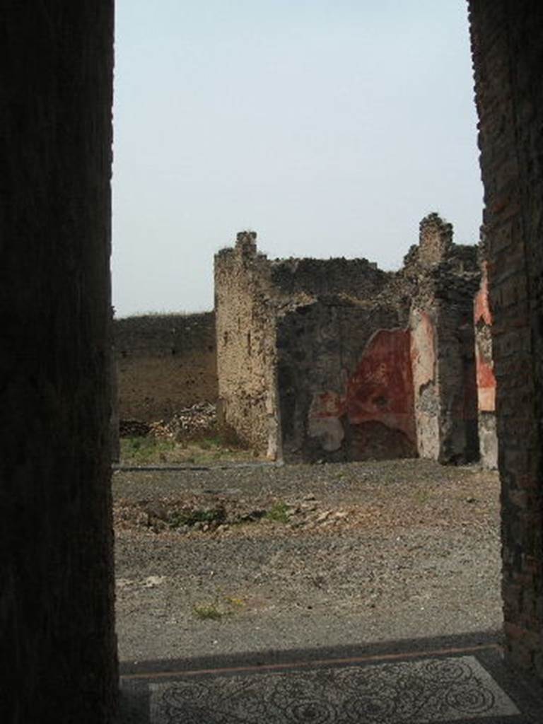 IX.5.14 Pompeii. May 2005. Looking north-west across atrium "b". The doorway to the peristyle can be seen on the left. The doorway to a triclinium can be seen on the right (not photographed) According to PPP, this room is �room f�, and found in it were the under-mentioned paintings. According to Richardson, found in triclinium �o� were the following paintings.  All now in Naples Archaeological Museum.
Pyramus and Thisbe,   (Naples Inventory number 111483), 
Pair of men before an enthroned queen (Aeneas before Dido?)   (Naples Inventory number 111480),  Bacchus and  Ariadne with thiasus   (Naples Inventory number 111481). See Richardson, L., 2000. A Catalog of Identifiable Figure Painters of Ancient Pompeii, Herculaneum. Baltimore: John Hopkins. (p.153)  See Bragantini, de Vos, Badoni, 1986. Pitture e Pavimenti di Pompei, Parte 3. Rome: ICCD. 
