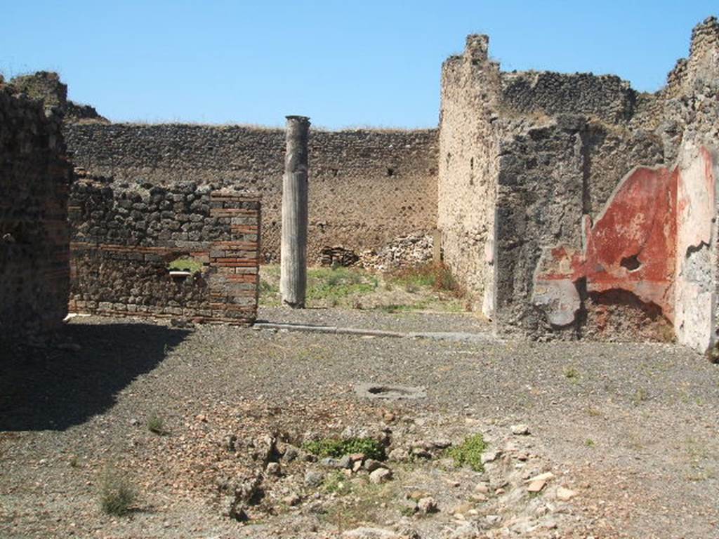 IX.5.14 Pompeii. May 2005. Looking west across impluvium in atrium towards the portico �k�.
On the right, the remains of the decorated walls in the north-west corner would have had a black zoccolo and middle zone with red panels.

