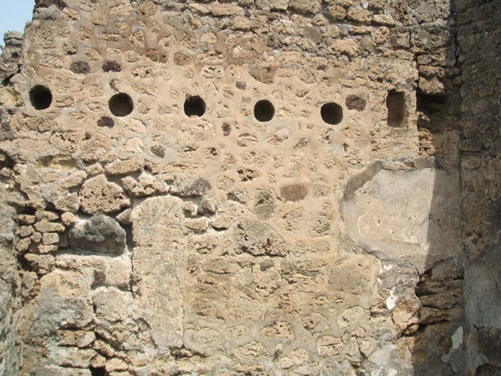 IX.6.4 Pompeii. May 2005. Room “x”, north wall with holes for joists to support upper floor.