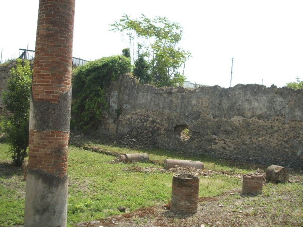 IX.6.5 Pompeii. May 2005. Peristyle garden area, looking south-east. In the south-east corner, behind the green plants and column, would have been rooms “s”, “t” and “u”.
According to Jashemski, the portico around the peristyle was supported on four sides by 16 columns. They were painted black below, and white with reddish cast above. The columns on the east side were joined by a low wall.
See Jashemski, W. F., 1993. The Gardens of Pompeii, Volume II: Appendices. New York: Caratzas. (p.238)
