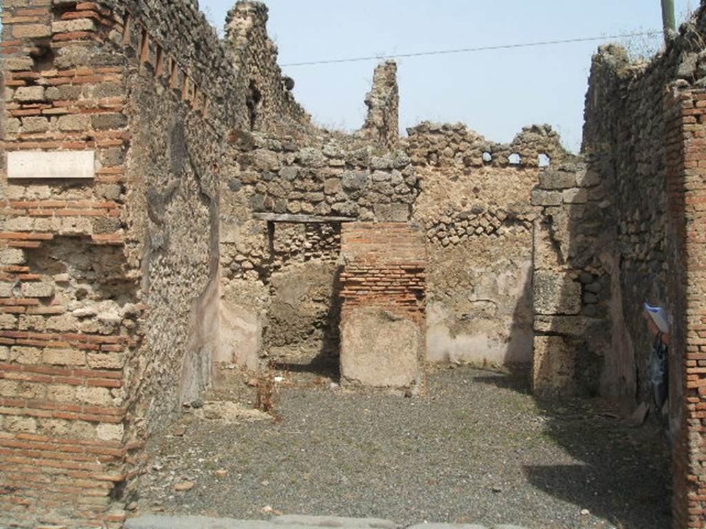 IX.6.a Pompeii. May 2005. Entrance doorway, looking north across large shop-room.
According to Eschebach, on the left was the hearth and steps to upper floor, with latrine beneath. See Eschebach, L., 1993. Geb�udeverzeichnis und Stadtplan der antiken Stadt Pompeji. K�ln: B�hlau. (p.428)
According to Flohr, see below, the stairs were in the rear room. This room identified as a shop or workshop had never been identified as a fullonica prior to his excavation in the north-west corner of the shop-room. The remains of the two low walls and a small platform, with space between the walls were thought to have been fulling stalls. Surface cleaning around the possible fulling installation confirmed the hypothesis.
See Rivista di Studi, XVIII, 2007, article by Flohr, M, entitled Cleaning the laundries report of the 2006 season, (p.134)
According to Mau, this was a shop with two rooms, one of them having a separate entrance from the western vicolo (IX.6.1). The shop and the room to the right had walls painted with a high flesh-coloured zoccolo (plinth); in the other room the plaster was not conserved.
See Mau in BdI 1881, (p.32), (described as number 14).
According to Varone, CIL IV 5203, 5204 and 5206 were found on the wall between IX.6.a and IX.6.b (see IX.6.b for details).
See also Mau in BdI 1881, (p.32)


