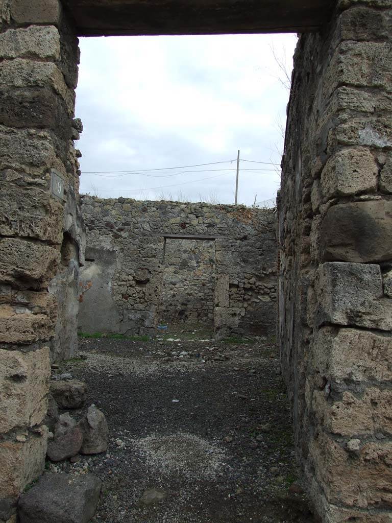 IX.7.19 Pompeii. December 2007. Looking east towards entrance doorway on Vicolo di Tesmo. 
According to Mau, the threshold or doorsteps of both doorways, IX.7.19 and IX.7.18 were missing when excavated.
See Mau, Bullettino dell’Instituto di Corrispondenza Archeologica (DAIR), 1883, (p.78).
