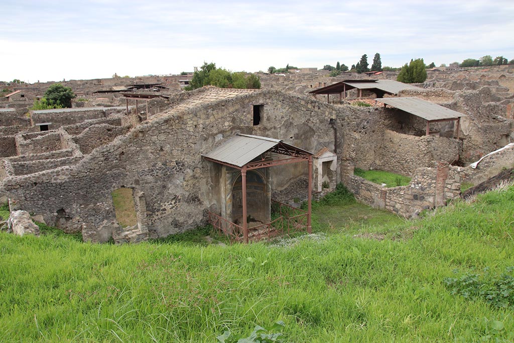 IX.7.16 (?) or IX.7.(?) Pompeii. October 2024. Mosaic fountain area at rear of IX.7.20. Photo courtesy of Klaus Heese.
According to PPM, in relation to IX.7.16,
"The mosaic fountain, present in the partially excavated garden, located to the E of the peristyle of the house at no. 20, was added to this house [IX.7.16], since it was reachable from it". 
This is number 8 on their plan, continuing the IX.7.16 numbering.
See Carratelli, G. P., 1990-2003. Pompei: Pitture e Mosaici: Vol. IX, Parte II. Roma: Istituto della enciclopedia italiana, p. 783.


