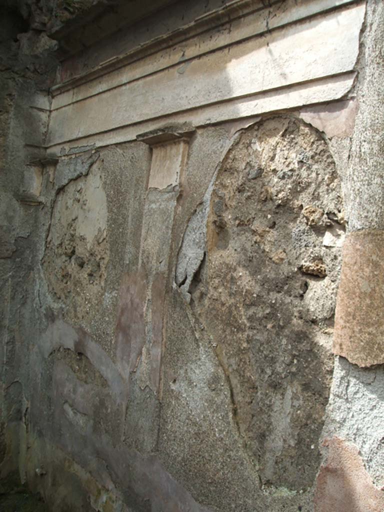 IX.7.25 Pompeii. May 2005. West wall of garden area “u”, with remains of moulded cornice.
According to Jashemski, Mau had said on the south garden wall (not photographed here), to the right (west) of the door leading to a back room, there was a painting of a kind of pavilion.
This was formed by four columns in which stood a large crater fountain (79cm high).
It was decorated with plant and animal motifs in high relief.
The jetting water fell back into the crater from a height of about 20cm.
Fortunately, Tatiana Warscher had photographed the now-destroyed detail.
She said this was found “at the base of the middle of the garden wall”.
Nothing remains today.
See Jashemski, W. F., 1993. The Gardens of Pompeii, Volume II: Appendices. New York: Caratzas. (No.96 on p.366).
The Tatiana Warscher photograph can be seen on page 367, fig. 430 of the same book.
Jashemski also included a mosaic fountain at IX.7.25, that we have included in IX.7.20.
See Jashemski, W. F., 1993. The Gardens of Pompeii, Volume II: Appendices. New York: Caratzas. (p.242).
See Boyce G. K., 1937. Corpus of the Lararia of Pompeii. Rome: MAAR 14. (p.89, no.446, he gives the location as IX.7.?)