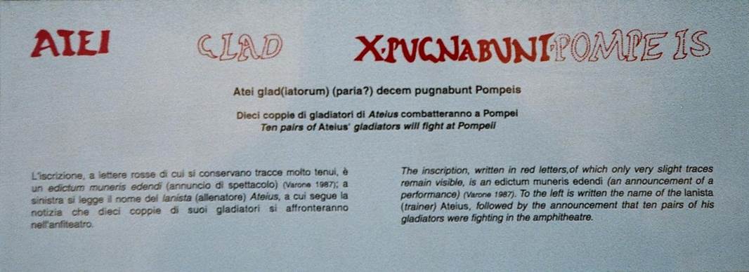 IX.8.2 Pompeii. October 2009. Explanation of painted latin inscription. Atei glad(iatorum) (paria?) decem pugnabunt Pompeis. Ten pairs of Ateius� gladiators will fight at Pompeii. Photo courtesy of Rick Bauer.