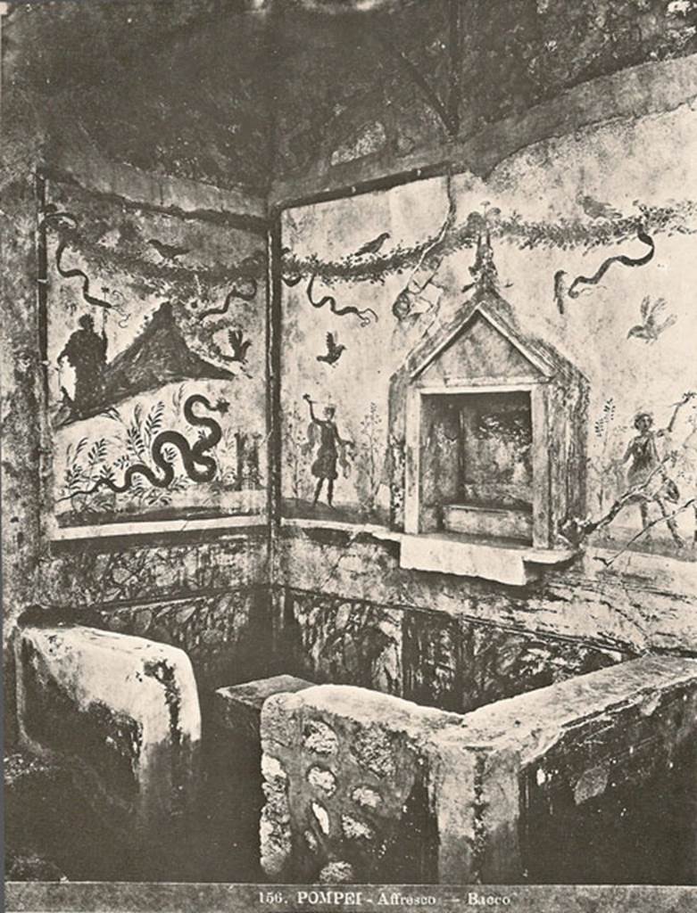 IX.8.6 Pompeii. Old photo no. 156, possibly just after excavation circa 1879-1881?
Room 23. Servants’ quarters on west side of house.
Household shrine or lararium with Bacchus painting still in situ.
According to Boyce –
In the south wall within the precinct is a rectangular niche (h.0.56, w.0.51, d.0.26, h. above floor 1.25), adorned with an aedicula facade (h.1, w.0.64), of grey marble, consisting of a plain rectangular slab on each side of the niche, a pediment above and a heavy block (0.12 thick) projecting on the level of the floor. Within the niche a low step is built against the back wall and in front of it a circular depression for offerings is cut in the block that forms the floor. In the pediment is painted an owl. On the wall on each side of the niche is the painted figure of a Lar with rhyton and situla, standing between two trees.
On the adjoining east wall is the panel with the famous painting of Bacchus beside Vesuvius…….. (Now in Naples Museum).
See Boyce G. K., 1937. Corpus of the Lararia of Pompeii. Rome: MAAR 14. (p.89-90, no.448).