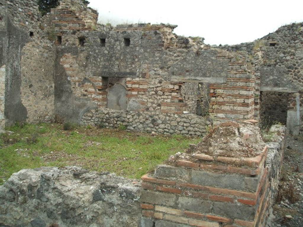 IX.9.a Pompeii. May 2005. Looking south across room �f�, garden from north-west corner.
According to NdS, the peristyle �f� was surrounded by a portico on two sides, the north and west. The portico was supported by plastered brick pilasters, and by one tufa column in the south-west corner. The pilasters were connected by means of a wall between them, and at the base was a channel for rainwater. See Notizie degli Scavi, 1888, p.515.
