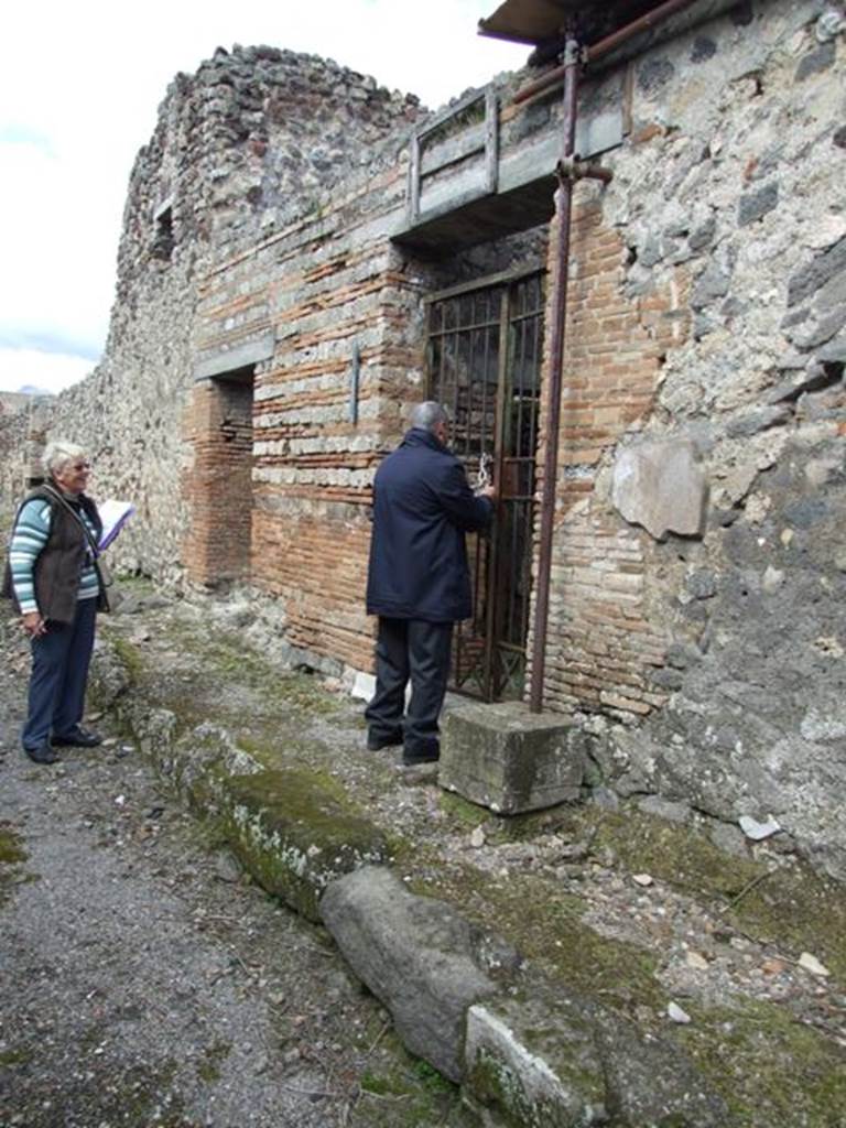 IX.9.c Pompeii. March 2009.  Entrance, looking north, with entrance at IX.9.b to the north. According to Della Corte, two seal/signets were found here. One with the name of - C. Sulpicius Rufus  (S.90), and the other Q. Nolanius Primus  (S.63). On the south side (right of doorway) a graffito was found with the initials Q.N. (CIL IV 5330). 
Also found in the house were amphorae, several bearing the initials or name of Caesia Helpis and a certain Vibia.  C(aesiae H(elpidi) ab Vibia  (CIL IV 5792).  
Three amphorae with their writing - Caesiae Helpidis  (CIL IV 5789, 5791, 5793), according to Della Corte, made Cesia a producer of wine.
Della Corte thought, as had Mau, that Cesia was the wife of one of the named people on the seal/signet.  See Della Corte, M., 1965.  Case ed Abitanti di Pompei. Napoli: Fausto Fiorentino. (p.165)
According to Epigraphik-Datenbank Clauss/Slaby (See www.manfredclauss.de), these last three read as –
Caesiae Helpidis       [CIL IV 5789]
Caesiae Helpidi 
/ Vir 
Tolm 
/ IIAIX                             [CIL IV 5791]
PT VIIII 
PL x PT VIIII 
Caesiae Helpid(is)     [CIL IV 5793]
