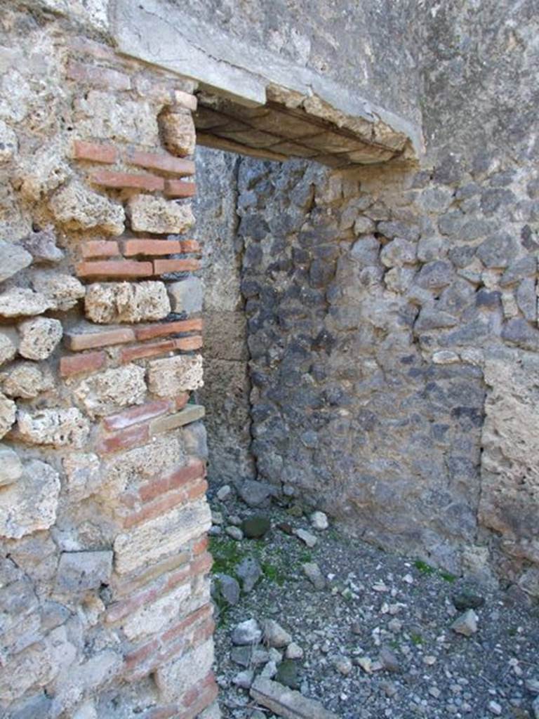 IX.9.d Pompeii. March 2009. Doorway to rooms h and i.  
Room with stairs to upper floor, and latrine underneath.
On the left of the doorway, on the wall of the atrium, a graffito was found. It read � 
CTXXXV
PLXXXVII
