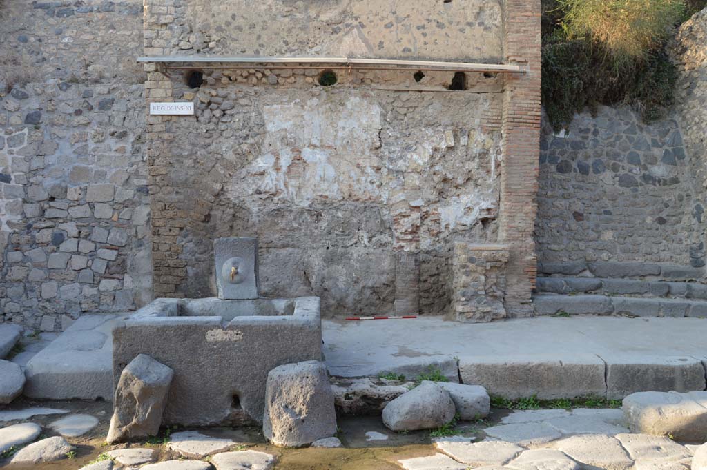 IX.11.1 Pompeii. October 2017. Looking north on Via dell�Abbondanza towards fountain with street shrine and altar, at the rear.
Foto Taylor Lauritsen, ERC Grant 681269 D�COR.
