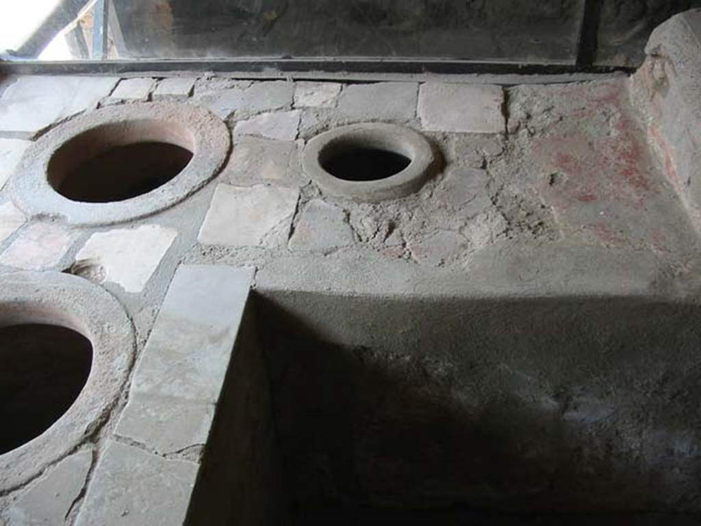 IX.11.2 Pompeii. May 2003. Two dolia on west side of counter. Photo courtesy of Nicolas Monteix.