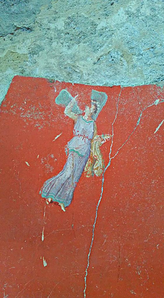 IX.12.6 Pompeii. 2016/2017.
Room “m”, painting of flying figure from south side of central painting on west wall.
Photo courtesy of Giuseppe Ciaramella.