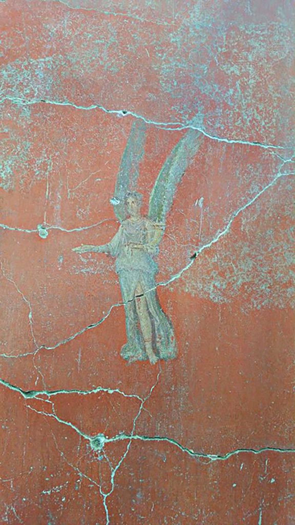 IX.12.6 Pompeii. 2016/2017.
Room “m”, flying figure on east side of central painting on north wall.
Photo courtesy of Giuseppe Ciaramella.