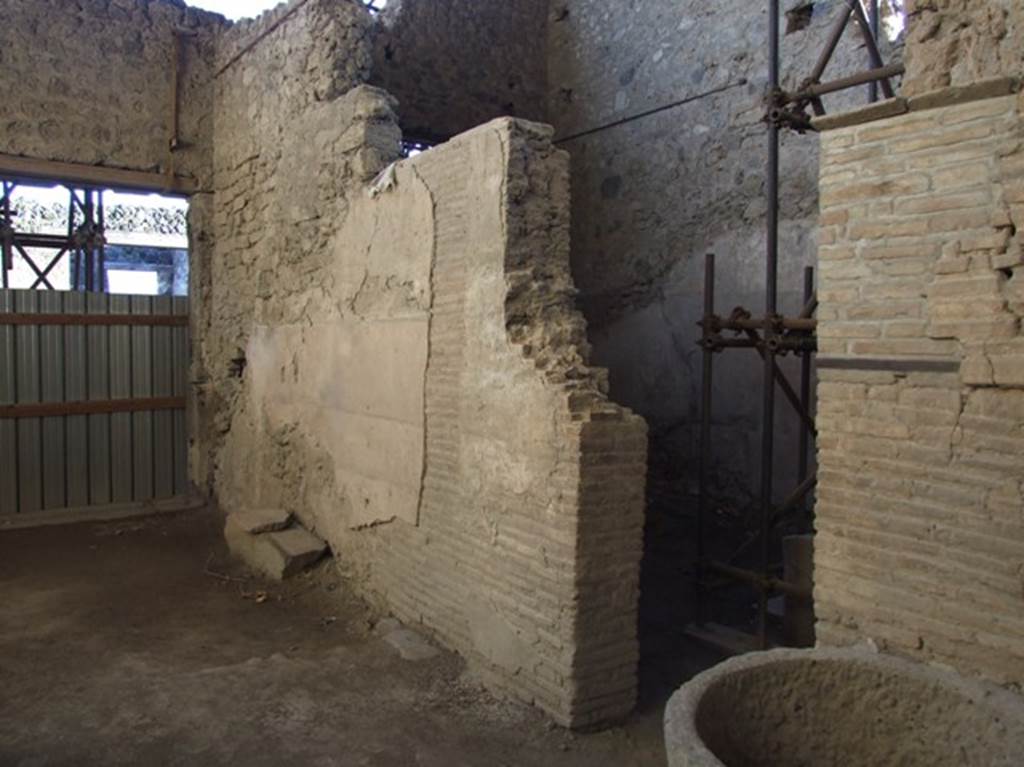 IX.12.6 Pompeii. March 2009. Room “b”, west wall, with door into room “a”, probably used for grinding the corn and making the bread.