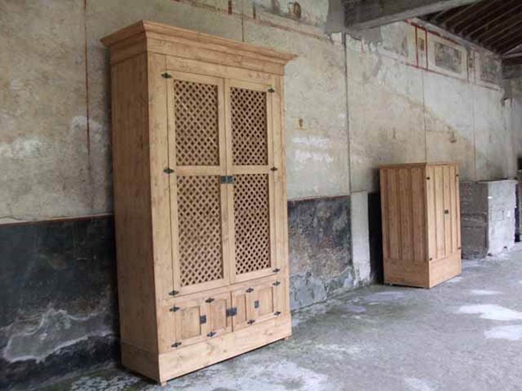 IX.13.1-3 Pompeii. May 2010.  Room 9, east portico, with reproduction cupboards.