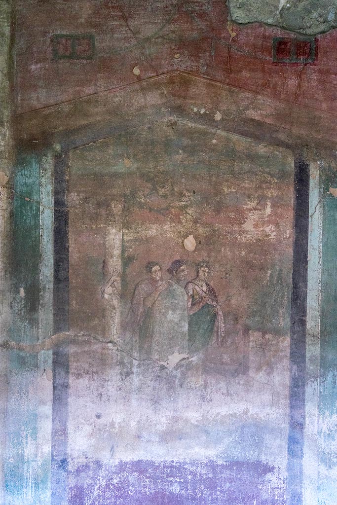 IX.14.4 Pompeii. July 2024.
Room 3, central painting with three figures on south wall. Photo courtesy of Johannes Eber.