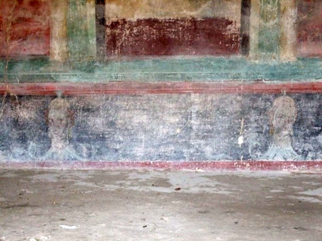 IX.14.4 Pompeii. December 2007. Room 3, oecus south wall. Painting of heads on lower zoccolo of south wall.