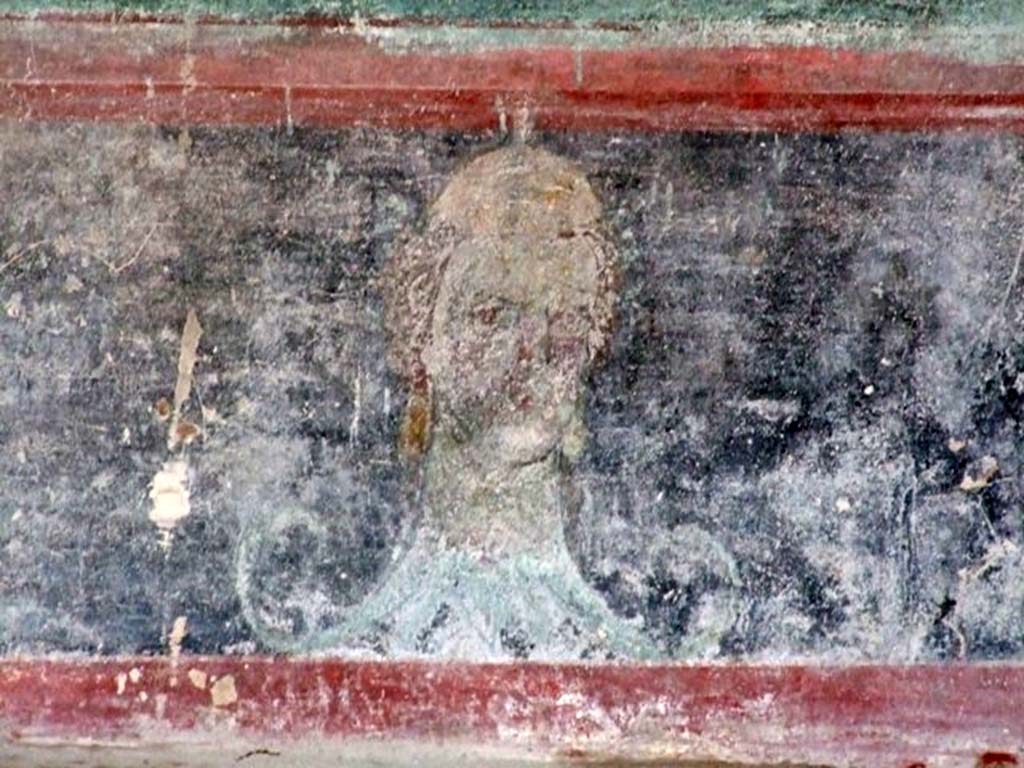 IX.14.4 Pompeii. December 2007. Room 3, painting of head on zoccolo of south wall at west end.