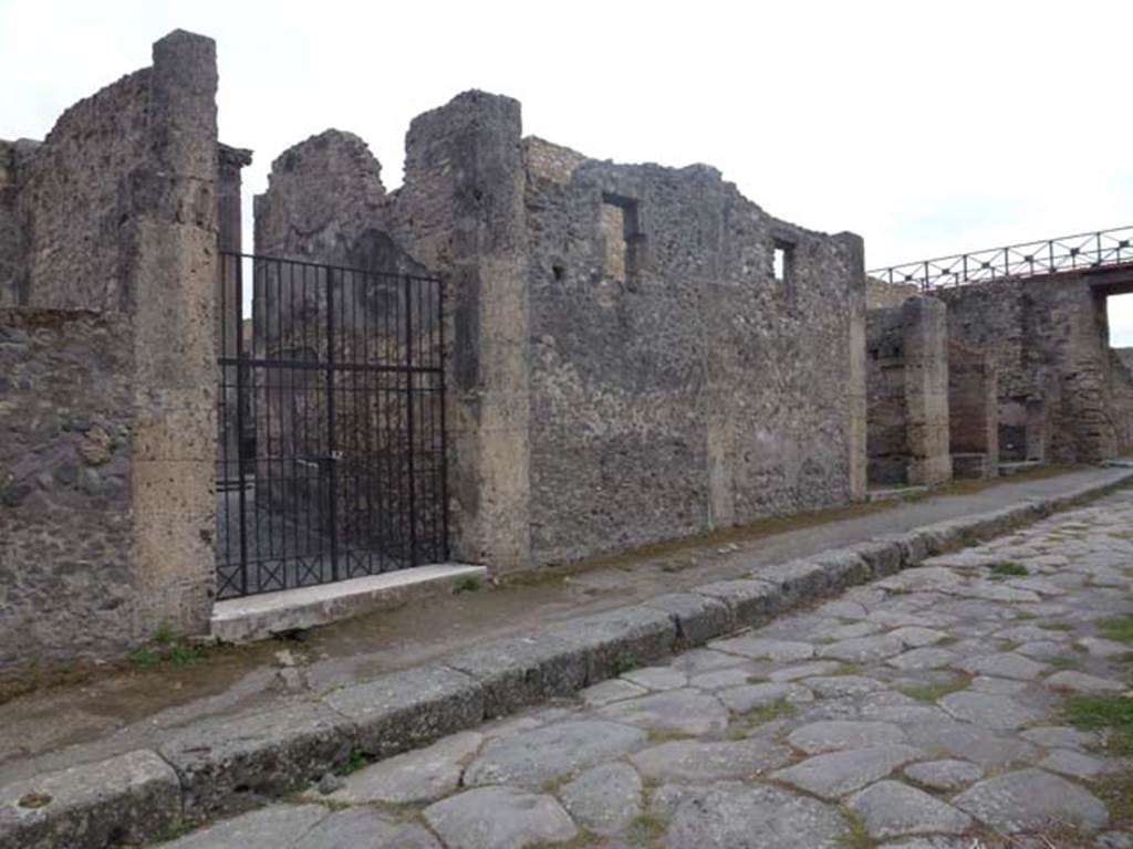 IX.14.4 Pompeii. September 2011. Looking south-west on Via di Nola, towards entrance doorway, on left. IX.14.3, IX.14.2 and IX.14.1 can be seen, on the right. Photo courtesy of Michael Binns
