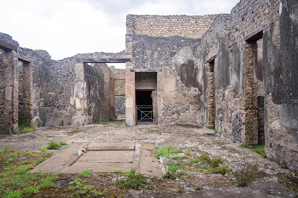 IX.14.4 Pompeii. July 2024. 
Looking north across secondary atrium 27 at IX.14.2 towards entrance doorway. Photo courtesy of Johannes Eber.
