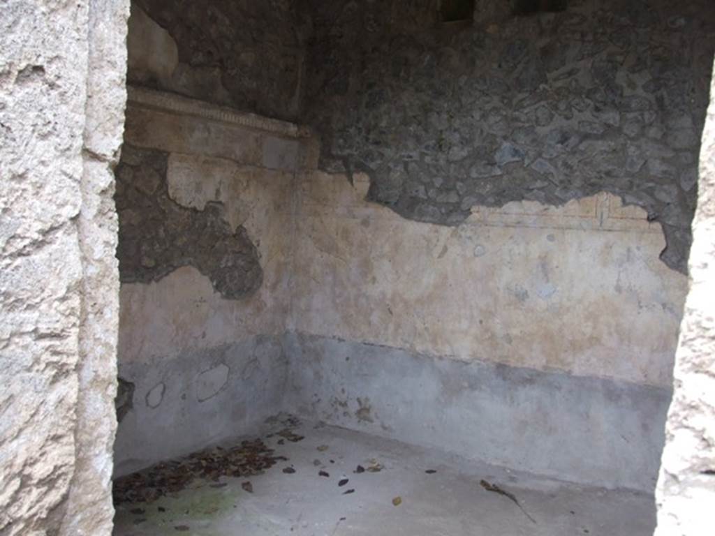 IX.14.4 Pompeii. December 2007. Looking west into room 21, cubiculum on west side of secondary atrium at IX.14.2. According to NdS, on 23rd May 1911, a human skeleton with iron keys and a hoard of coins was found near the doorway to this room. See Notizie degli Scavi 1911, (p.218). The floor was similar to the secondary atrium, being concrete scattered with white marble chippings. The threshold or sill would have been wooden, as were the doorjambs. The walls were decorated with a grey plinth at the base, above which the walls were painted white. On the walls were ashlar divisions, the first large and vertical, the other small and horizontal. Above the ashlar was a white cornice, actually protruding from the wall, and above that further white walls. The top of the wall and ceiling had disappeared.
See Notizie degli Scavi, 1911, (p.267).