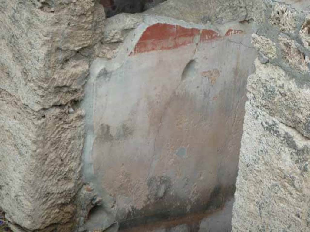 IX.14.c Pompeii. May 2010. Room 1, entrance corridor or fauces, north wall (left). The walls of the fauces or entrance corridor were painted with a black plinth, of large decorations likewise black. The red frieze was divided into rectangles by thin bands. The painting on the north wall was the best preserved. See Notizie degli Scavi di Antichit�, 1911, p. 374.