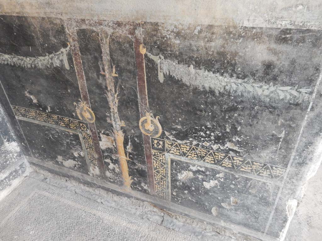 Villa San Marco, Stabiae, June 2019. Room 44, black painted zoccolo on west side of entrance doorway.
Photo courtesy of Buzz Ferebee.
