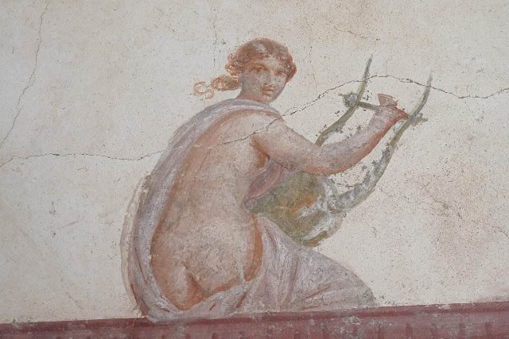 Castellammare di Stabia, Villa San Marco, July 2010. Room 30, painted figure with lyre from upper south wall in south-east corner. Photo courtesy of Michael Binns.