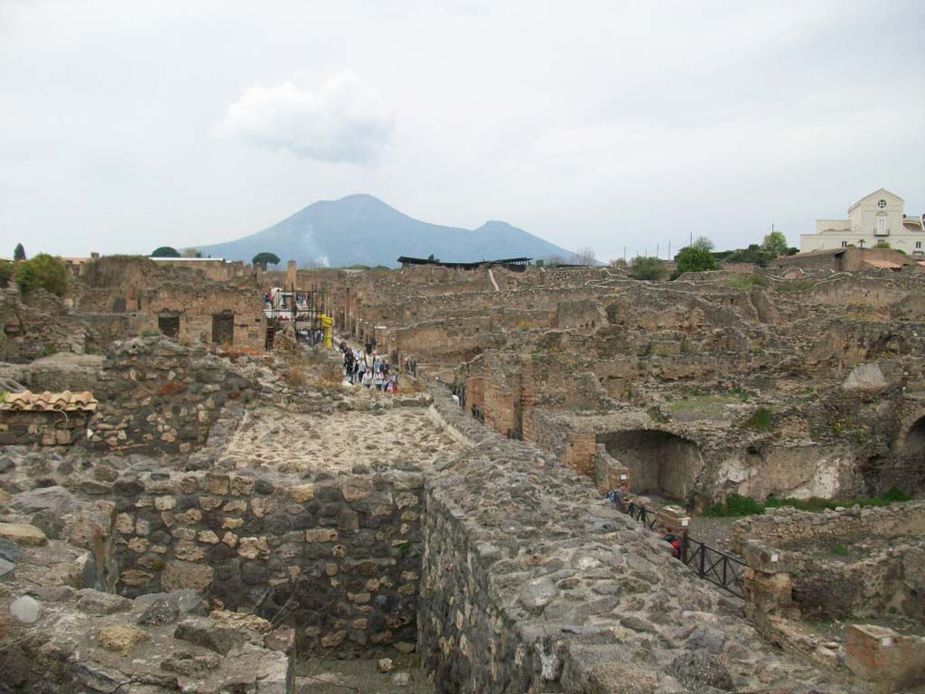 Via Stabiana, April 2010. Looking north from near upper peristyle area of VIII.7.24, centre left.
Reg. VIII.7. is on the left, and Reg. I.3. is on the right.  Photo courtesy of Klaus Heese.
