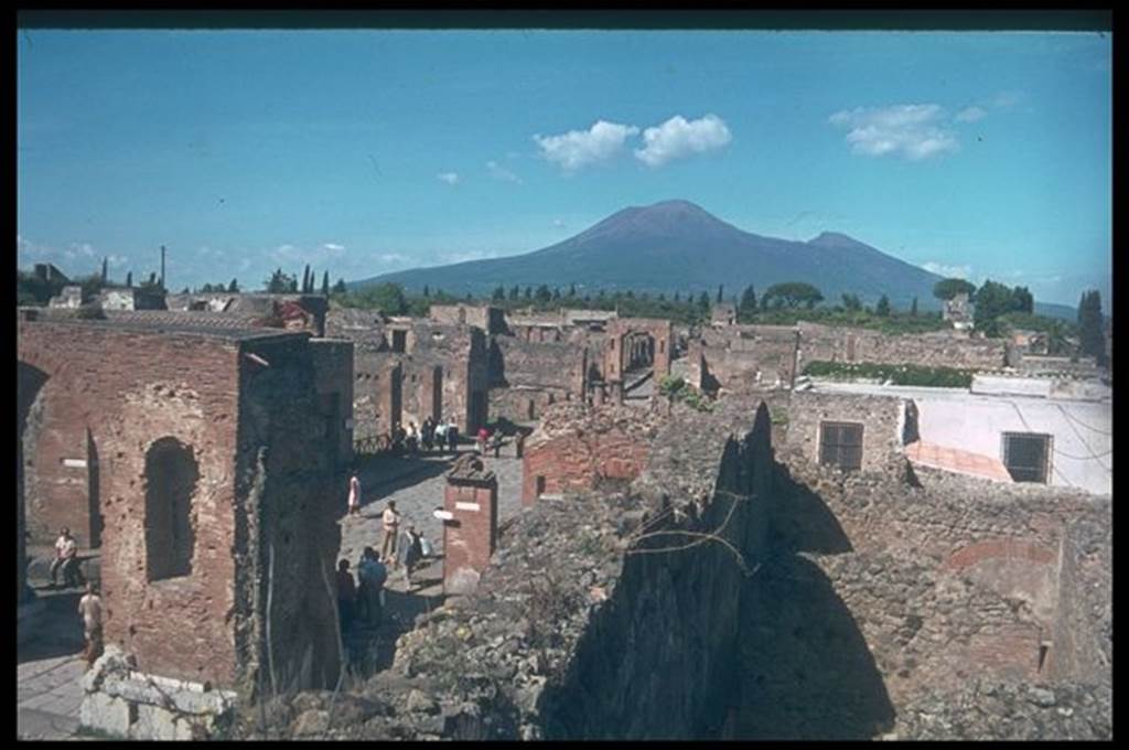 Via del Foro between VII.5 and VII.4. Looking north towards Vesuvius, from top of scaffolding in shop VII.9.9 on the Forum.  Photographed 1970-79 by G�nther Einhorn, picture courtesy of his son Ralf Einhorn.

