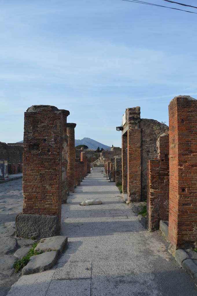 Via del Foro, east side, Pompeii. March 2019. 
Looking north along pavement underneath portico, from pilaster/column at south end. 
Foto Taylor Lauritsen, ERC Grant 681269 D�COR.

