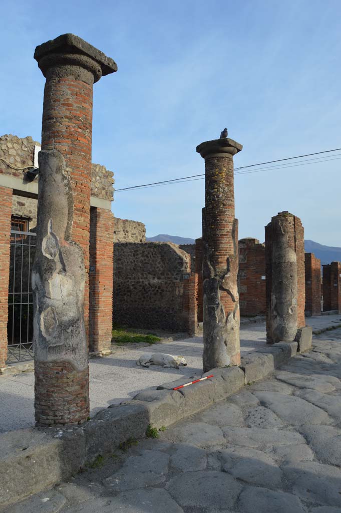 Via del Foro, east side, Pompeii. March 2019. 
Looking south-east towards third and second column from south end with pilaster/column at south end, on right, outside VII.4.12. 
Foto Taylor Lauritsen, ERC Grant 681269 D�COR.

