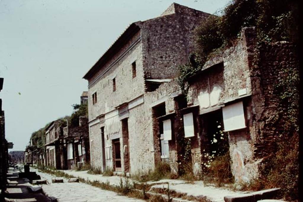Via dell’Abbondanza, north side, Pompeii. 1976. Looking west along IX.13. Photo by Stanley A. Jashemski.   
Source: The Wilhelmina and Stanley A. Jashemski archive in the University of Maryland Library, Special Collections (See collection page) and made available under the Creative Commons Attribution-Non Commercial License v.4. See Licence and use details. J76f0551

