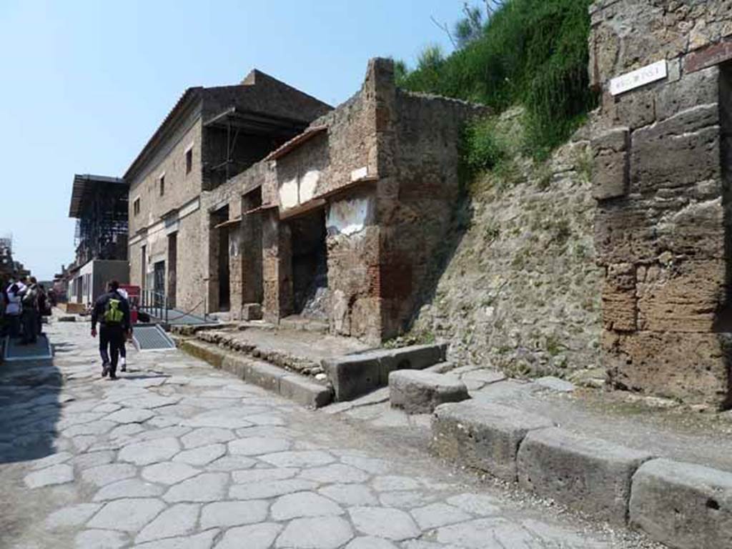 Via dell’Abbondanza, north side. May 2010. Looking west from near III.1.1, towards unnamed vicolo and IX.13. 

