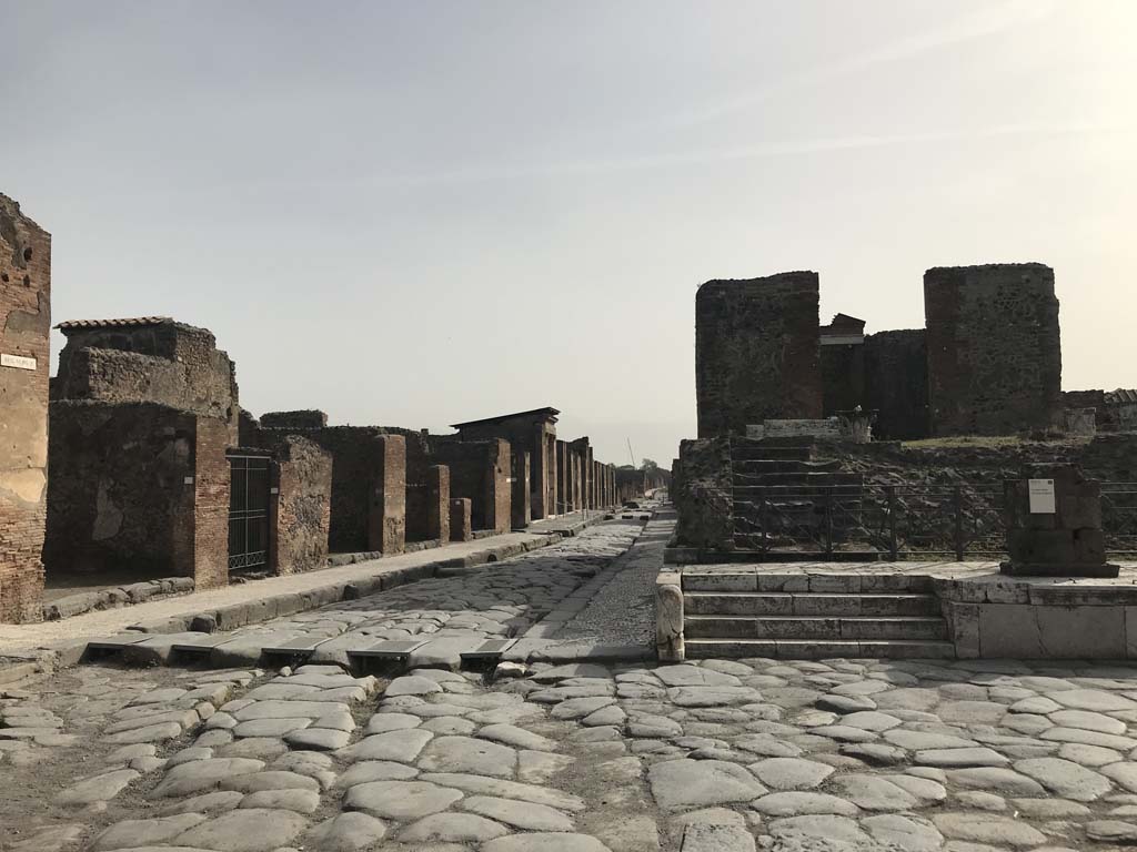 (North side of) Via della Fortuna straight ahead from crossroads with Via di Mercurio (on left) and Via del Foro (on right).  
Looking east from Via delle Terme. April 2019. Photo courtesy of Rick Bauer.

