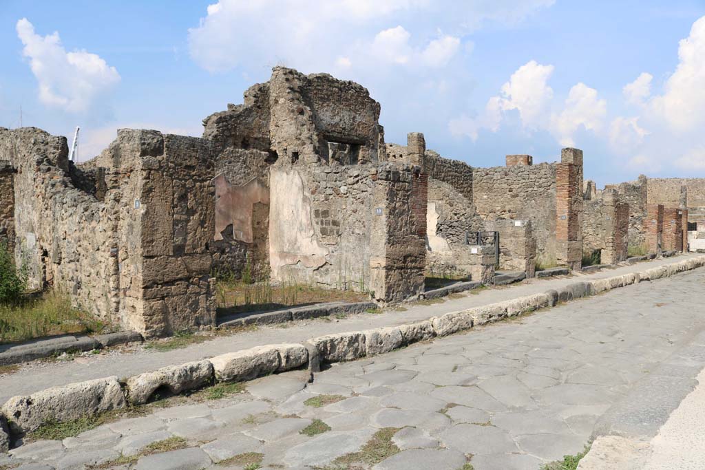 Via della Fortuna, north side, December 2018. 
Looking east along front façades of shops, from VI.14.9, on left. Photo courtesy of Aude Durand.
