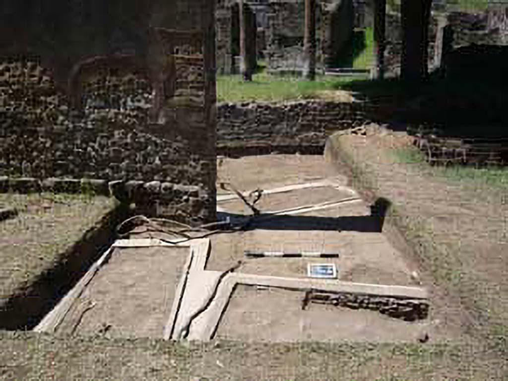 HGE15A Pompeii. 2009 re-excavation of three Samnite graves by the Via Consolare Project. 
The location of three graves is clustered around the base of the wall. 
The two graves in the metal frames are also visible on the other side of the gap in the wall.
Excavations in 2009 were carried out by the Via Consolare Project and their report commented that:
Extensive modern deposits were removed from the area, revealing three heavily reconstructed, irregularly-aligned inhumation cist-graves. 
It is likely that these constructions are the result of the excavations of A. Maiuri in the 1930-40�s and were a component of his preparations of the Villa for general display that included replanting the viridarium and running water to the nymphaeum.
Photo courtesy of the Via Consolare Project. See http://www.viaconsolareproject.org/research2009.html
