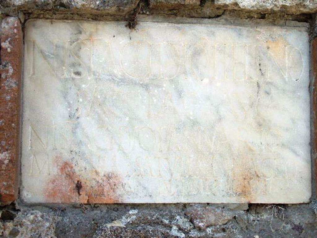 HGW21 Pompeii. May 2006. Marble plaque with Latin inscription.

N ISTIDACIO HELENO
PAG PAG AVG
N ISTADACIO IANVARIO
MESONIAE SATVLLAE IN AGRO
PEDES XV IN FRONTE PEDES XV
See Bonucci C., 1830. Pompei: 3rd edition. Naples: l�imprimerie Francaise. (p. 55-6).

According to Epigraphik-Datenbank Clauss/Slaby (See www.manfredclauss.de) this reads

N(umerio) Istacidio Heleno
pag(ano) pag(i) Aug(usti)
N(umerio) Istacidio Ianuario
Mesoniae Satullae in agro
pedes XV in fronte (p)edes XV      [CIL X 1027]

According to Cooley this translates as

To Numerius Istacidius Helenus, inhabitant of the Auigustan Country District; 
To Numerius Istacidius Ianuarius; 
To Mesonia Satulla. 
15 feet deep, 15 feet broad.

See Cooley, A. and M.G.L., 2004. Pompeii : A Sourcebook. London : Routledge. (p. 132, F99).