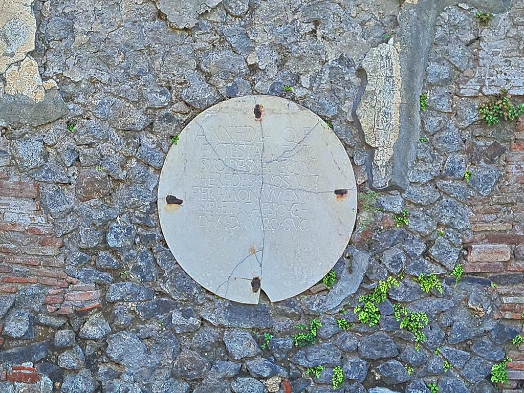 Pompeii Porta Nocera. October 2024. Tomb 29OS. Round marble plaque with inscription. Photo courtesy of Giuseppe Ciaramella.