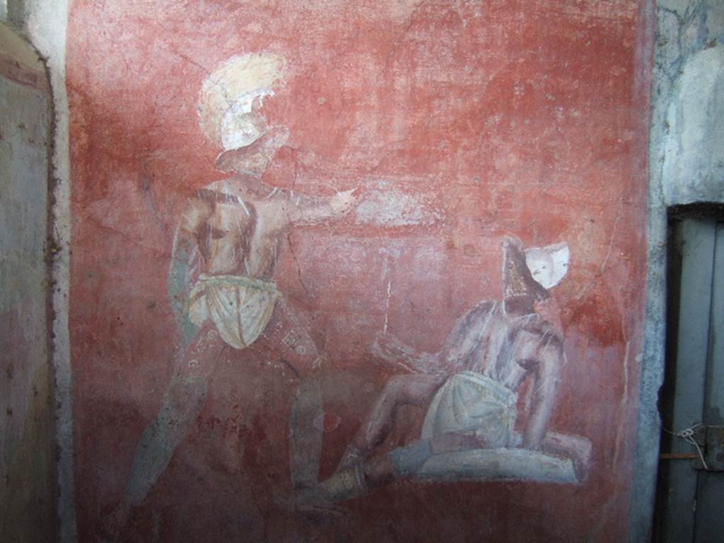 VGJ Pompeii. May 2006. Inner side of west wall of tomb with entrance door on right. Painting of a gladiator fight hosted by or held in honour of the deceased.