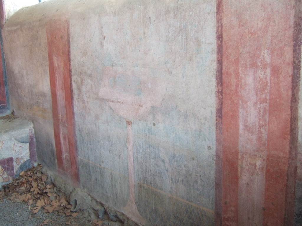 VGJ Pompeii. May 2006. Inner side of east wall of tomb with garden painting with low lattice fence.
A bowl fountain with a square brim stands in front of the fence and is supported by a tall slender pedestal.
The surrounding shrubs, now barely visible, were identified by Spano (NSc 1910) as Oleanders.
There were faint traces of birds. The painting is framed by two barely visible herms.
See Jashemski, W. F., 1993. The Gardens of Pompeii, Volume II: Appendices. New York: Caratzas. (103, p. 369)
See Notizie degli Scavi di Antichità, 1910, p. 402 and Fig. 11.