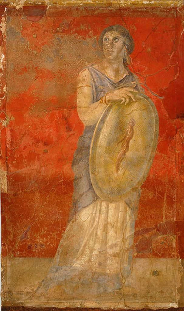 Villa of P Fannius Synistor at Boscoreale. Room H south end of east wall.
Standing woman clad in a white chiton and blue cloak, and holding a gold shield in her right hand. H
She is turning her head upwards to gaze towards the wall with Venus. 
The front of the shield shows the image of a standing nude male figure who is adorned with a white headband, the same as those worn by Hellenistic dynasts. 
This small male figure has been described as a reflected image on the shield, a popular motif in Hellenistic art. 
However, since there is no image in the fresco cycle that corresponds to a reflection, the figure should be understood as an apparition, which, in antiquity, was viewed as prophetic. 
The small apparition with a portrait like head in this particular fresco may refer to a Hellenistic royal heir, and the woman bearing the shield may represent a priestess or prophetess.
Photo � The Metropolitan Museum of Art, Rogers Fund 1903. Inventory number 03.14.7.
See www.metmuseum.org
See Barnabei F., 1901. La villa pompeiana di P. Fannio Sinistore. Roma: Accademia dei Lincei. p.57, Fig. 12.