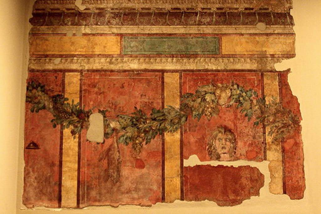 Villa of P. Fannius Synistor at Boscoreale. Room L, tablinum, rear wall. 
Garlands are supported by a ceremonial bulls head.
A satyr mask is in right hand panel which would have been the centre of the wall.
In the panel to the left of the mask a dead hare is suspended from the garland.
In the panel to the far left is a small cymbal (cymbalum).
Photo courtesy of Michel Wal, Wikimedia Commons. 
This photo is subject to an Attribution-ShareAlike 3.0 Unported licence.
Now in the Mus�e Royal de Mariemont, Morlanwelz, Belgium. Inventory number R61.
http://www.musee-mariemont.be/
