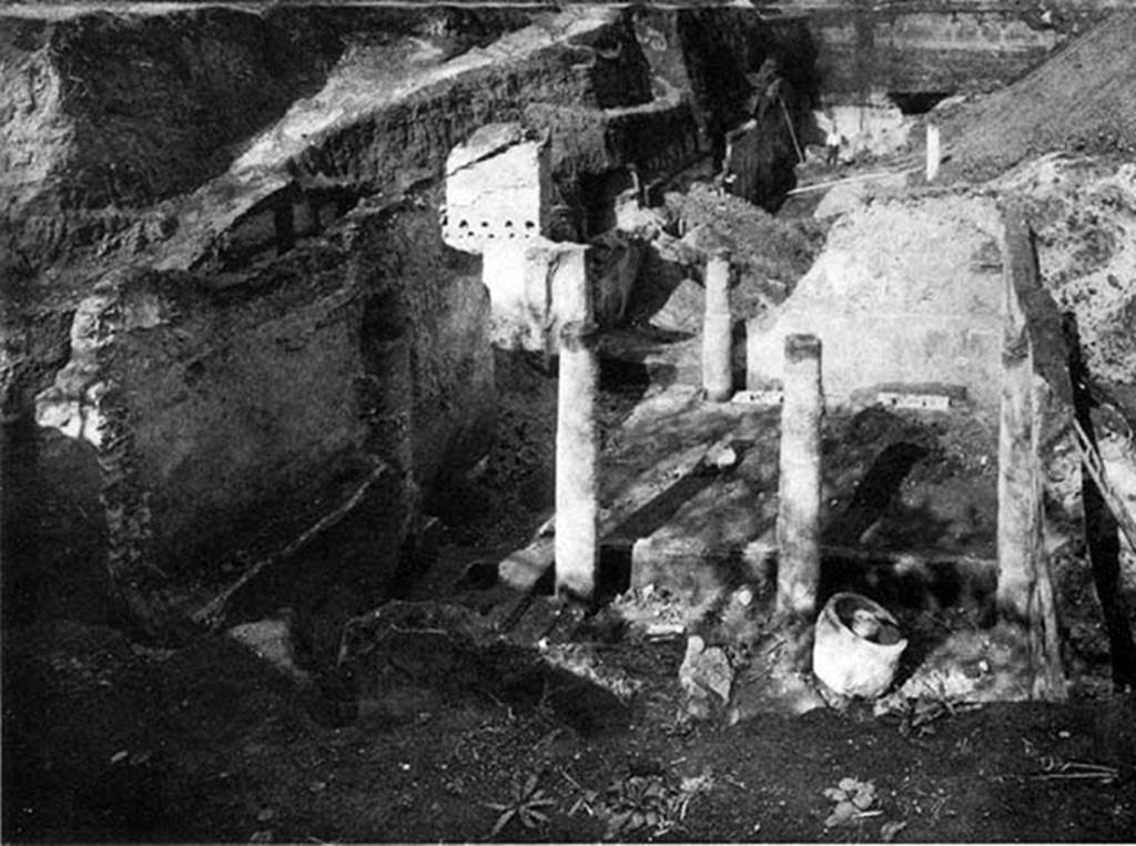 Villa of P. Fannius Synistor at Boscoreale. Room 24, work area during reburial in Mid September 1900.
According to Barnabei, the whole building was the owner’s house, except a portion (room 24) to the left of the entrance, which was used for the business.
A press for the grapes was discovered here, as well as a pitcher for the must.
An olive press (trapetum), a wine press (torcularium) and farming tools were found here.
There were also some bronze vessels, one of which had a handle of a figurine representing Bacchus, clad in silver leaf.
See Barnabei F., 1901. La villa pompeiana di P. Fannio Sinistore. Roma: Accademia dei Lincei. Tav. XI.