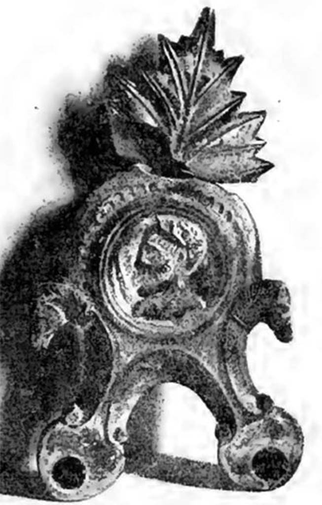 Villa of T. Siminius Stephanus, fondo Barbatelli. November 1899. A large glazed terracotta lamp with two lights: in the shield was seen in relief a bust with the head in profile, turning to the left. The head was graduated and bearded, and on his right shoulder rests the sceptre (Jupiter?). At the sides of the shield, two scrolls with the heads of horses. On the back of the leaf that surmounts the handle of enamelled terracotta lamp, following the cleanup of the lamp, were found the initials L N I. See Notizie degli Scavi di Antichit�, 1899, p. 445, fig. 7, p. 494.