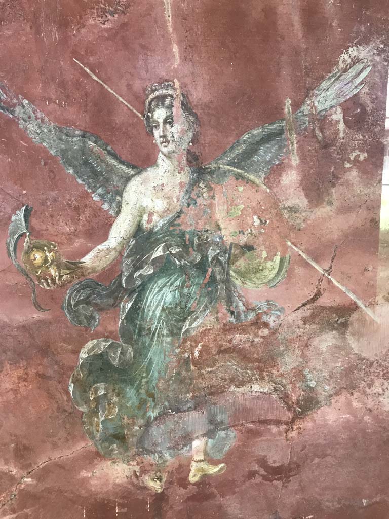 Complesso dei triclini in località Moregine a Pompei. April 2019. Triclinium C, west wall.
Winged Victory with the attributes of Athena.
Photo courtesy of Rick Bauer.
