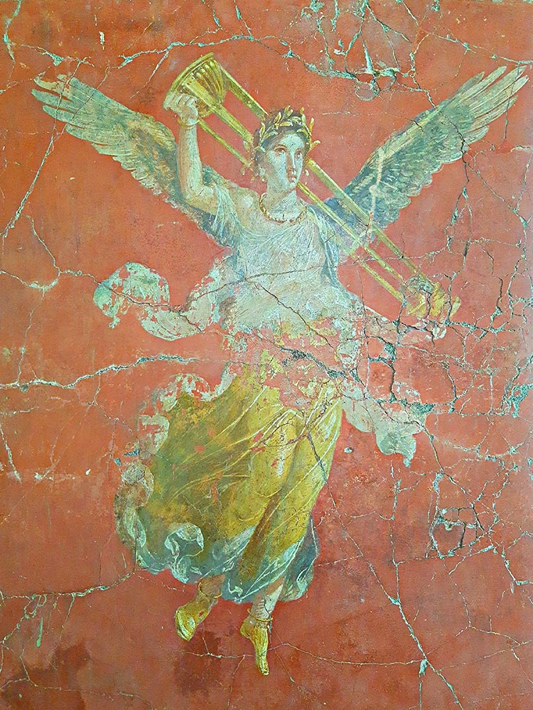 Complesso dei triclini in località Moregine a Pompei. September 2024.
Triclinium C, east wall.
Vittoria con tripode. Vittoria with tripod, on display in Pompeii Palaestra.
Vittoria alata con gli attributi di Apollo. Winged Victory with the attributes of Apollo.
This is shown on the east wall of triclinium C but may have come from Triclinium D or E.
Photo courtesy of Giuseppe Ciaramella.