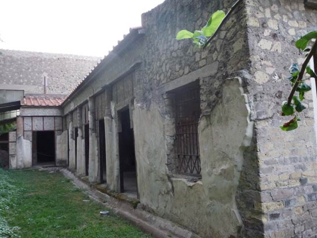 Oplontis, September 2011. Portico 24, looking west along garden area/peristyle, on outside of portico. On the left is the unexcavated. On the right is the corner leading into Portico 40, of peristyle 59. Photo courtesy of Michael Binns.
