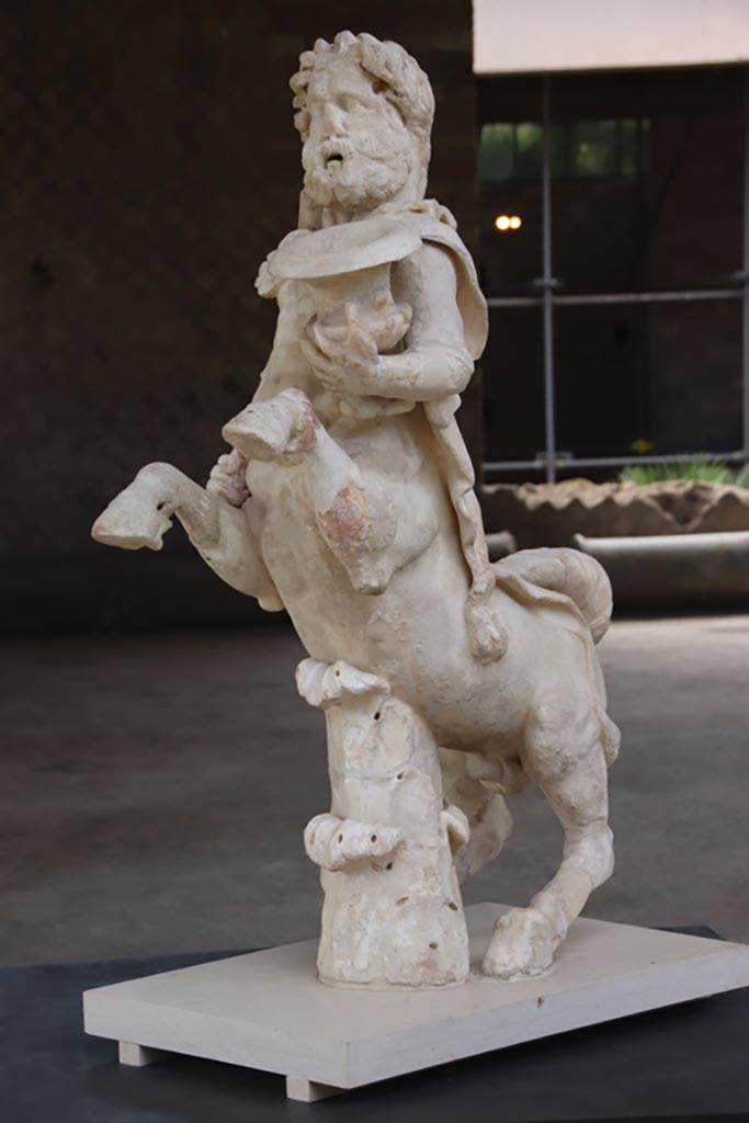 Villa of Poppaea, Oplontis, October 2023. 
Statuette of Centaur holding a club and a crater, on display in Room 21. Photo courtesy of Klaus Heese. 
