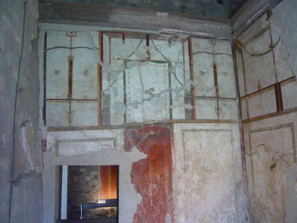 Oplontis, May 2010. Room 41, painted decoration on upper west wall of alcove.
The small doorway leads into room 38. Photo courtesy of Buzz Ferebee.